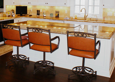 Custom made kitchen island with granite countertop and enameled inset cabinet doors.