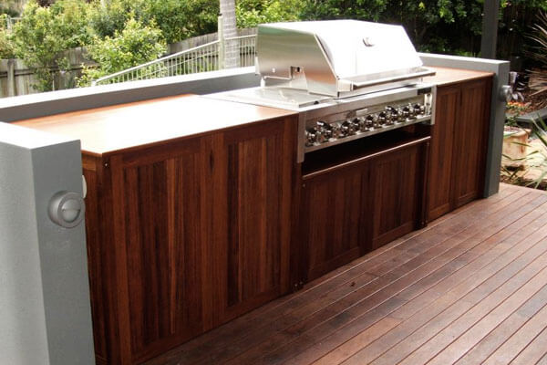 Outdoor kitchen patio cabinets in teak with stainless BBQ grill